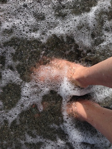 Surf foaming over feet