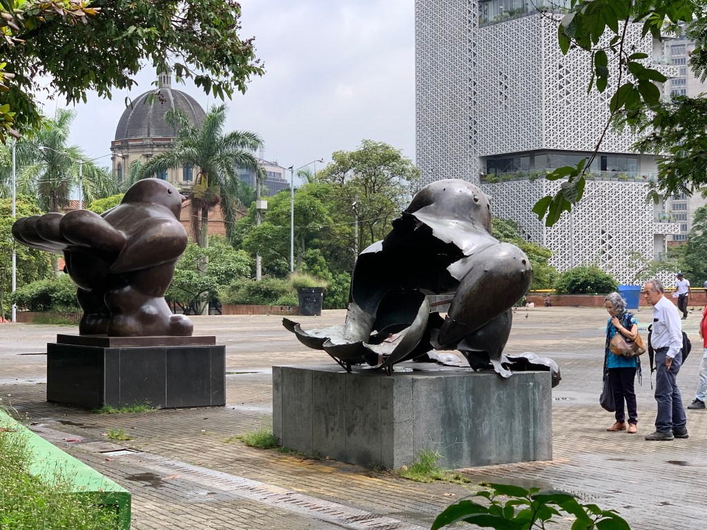 Two bird statues in Medellín by Botero. One is intact and one was half blown off by a bomb.
